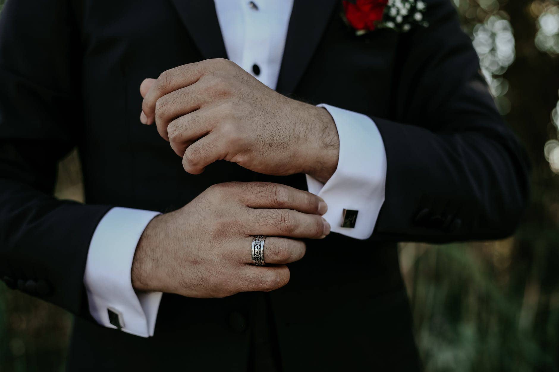 close up on mans hands in wedding suit